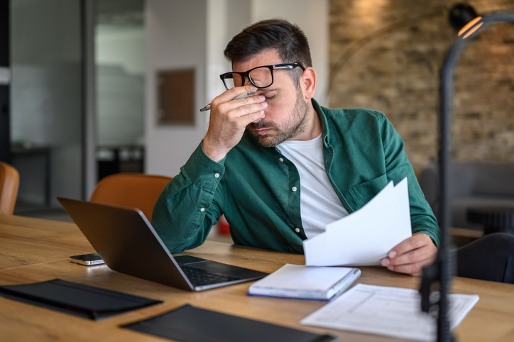 Anxious man doing his finances.