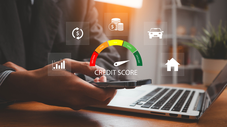 A man on a computer, with the credit score icon.